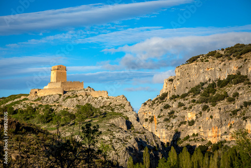 View from the distance of the medieval Taibilla castle in Nerpio, Albacete, Castilla la Mancha, Spain in a rocky setting at sunset