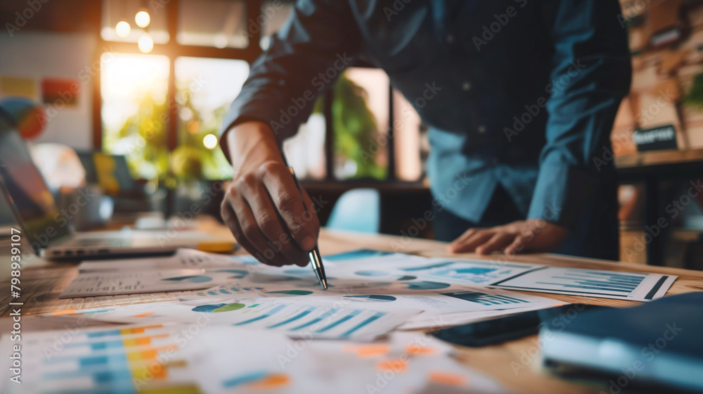 A business owner leading a team meeting to discuss progress and set goals for the upcoming quarter. Diligence and work, team and trust, profit A business owner leading a team meeting to discuss progress and set goals for the upcoming quarter. Diligence and work, team and trust, profit