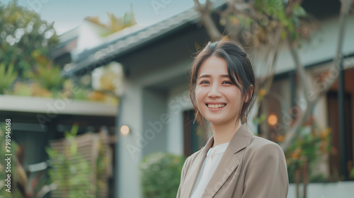 Woman in front of home real estate sale concept photo