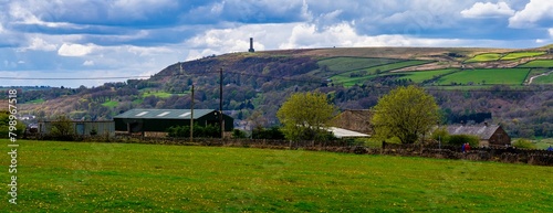 Photography Panoramic image of green fields and peel tower at the top of the hill in Ramsbottom, Greater Manchester