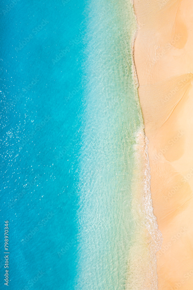 Relax aerial beach scene, summer vacation holiday pattern. Waves surf with amazing blue ocean lagoon, sea sand shore, coastline. Summertime aerial drone top view. Peaceful bright Mediterranean seaside