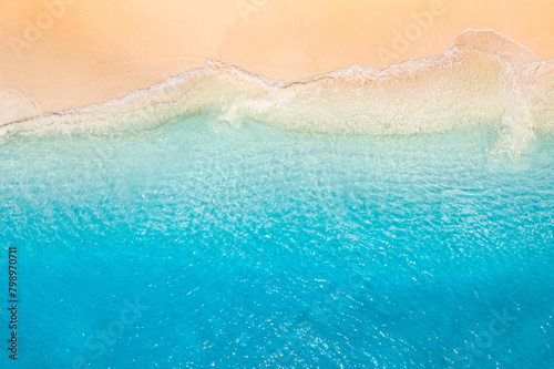 Relax aerial beach scene, summer vacation holiday pattern. Waves surf with amazing blue ocean lagoon, sea sand shore, coastline. Summertime aerial drone top view. Peaceful bright Mediterranean seaside © icemanphotos