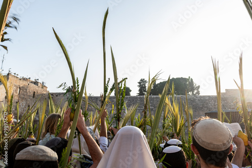 Worshippers at the Western Wall in Jerusalem raise a lulav or closed palm frond while praying on Hoshana Rabbah, the seventh day of the Jewish holiday of Sukkot.