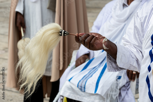 Ethiopian man holding a horse hair fly whisk during prayers in Jerusalem, Israel. photo