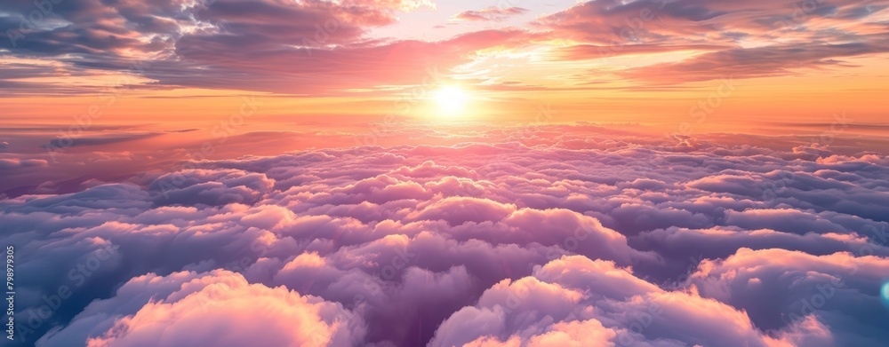 Beautiful sunset and cloudy sky from aerial view. Airplane view above clouds, panoramic banner background.