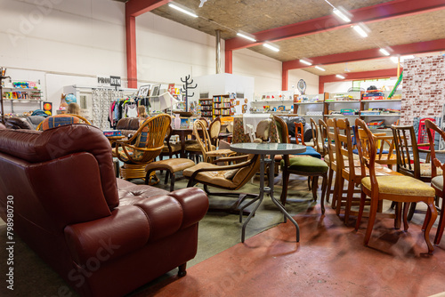 A big furniture store, second-hand. A lot of different furniture in the warehouse. photo