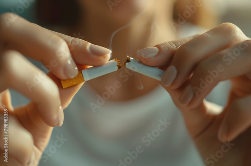 Close up of hands breaking cigarette  no tobacco stop smoking anti drug day concept