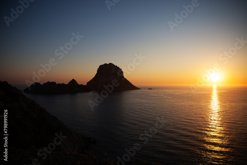 sunset over the sea of ibiza from a cliff