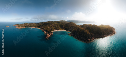 Radical Bay Beach at Arcadia at Magnetic Island near Townsville in Queensland, Australia - Aerial drone footage with rocks, waves, cliffs, ocean, trees, coast, views and scenery.