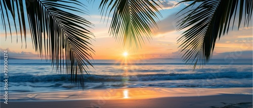 Sunset on the beach and palm trees by the warm ocean, with the sun setting behind the horizon, creating a heavenly scene of nature's beauty during the warm summer evening