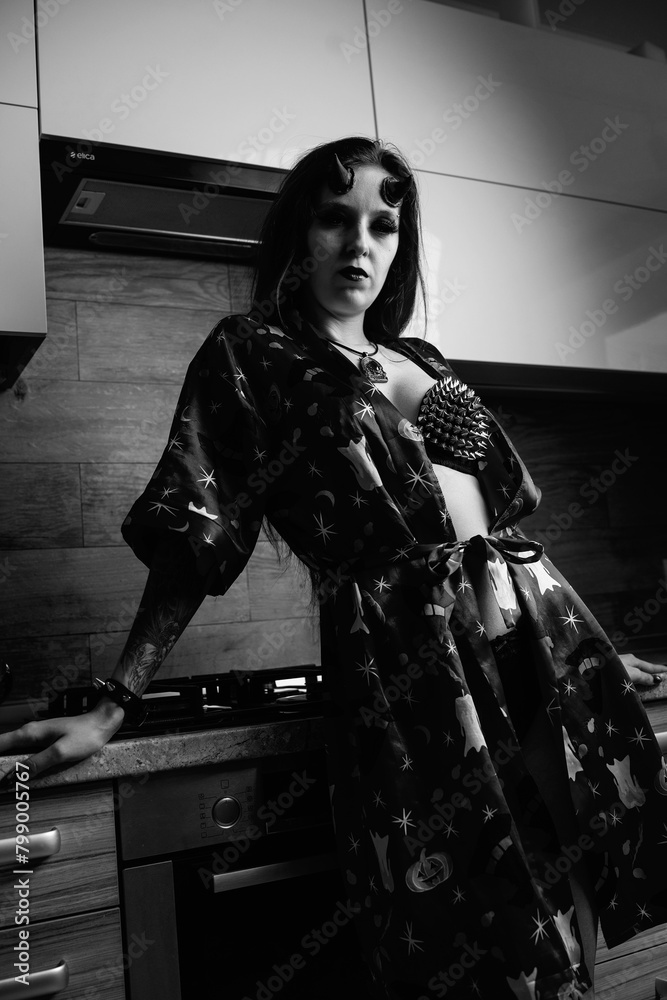 Naklejka premium Portrait of a young beautiful girl in the form of a demon. Black and white photo.