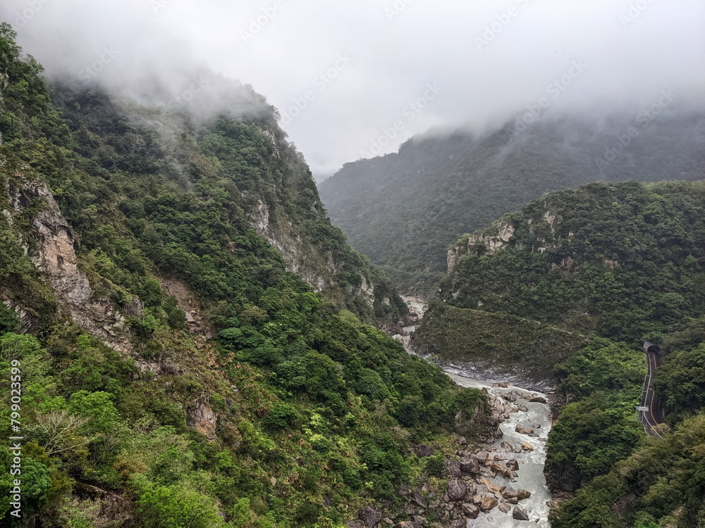 Taroko, Taiwan - 11.26.2022: Central Cross-Island Highway in Liwu River Gorge along cliffs and trees with mountains covered in mist, view from Buluowan Cable Suspension Bridge before 403 earthquake