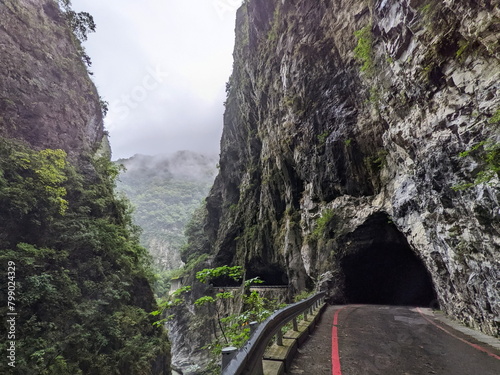 Taroko, Taiwan - 11.26.2022: Swallow Grotto Trail with no people passing through marble cliffs in the narrow Liwu River gorge in the mist before the 403 earthquake during the pandemic on a rainy day photo