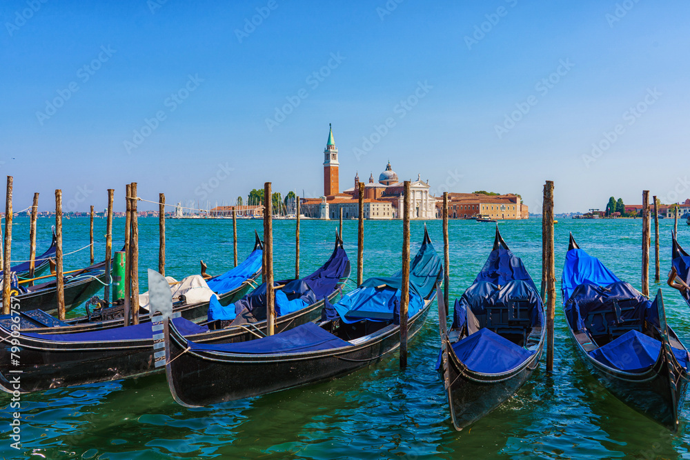 View of the gondolas of the Grand Canal on a sunny day in Venice, Italy. San Giorgio Maggiore.