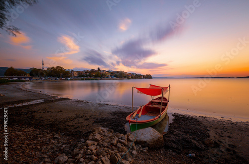 Wide view of fisherman boats in Ulubat Lake, Golyazi, Bursa, Turkey, big tree lakeside, sunset
