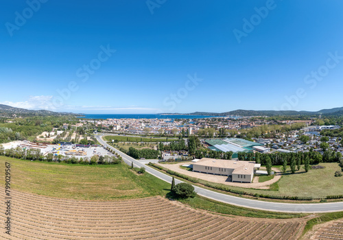 Panorama, Port Grimaud harbor in France in springtime with yachts and sailboats and Mediterranean Sea in the evening, drone shot, Cote d'Azur