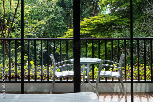 Nature view of balcony with steel chair and table on the sunny day