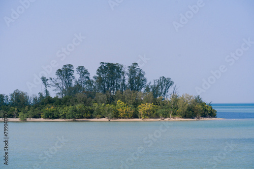 Side view of an isolated island in the middle of the sea. Private island