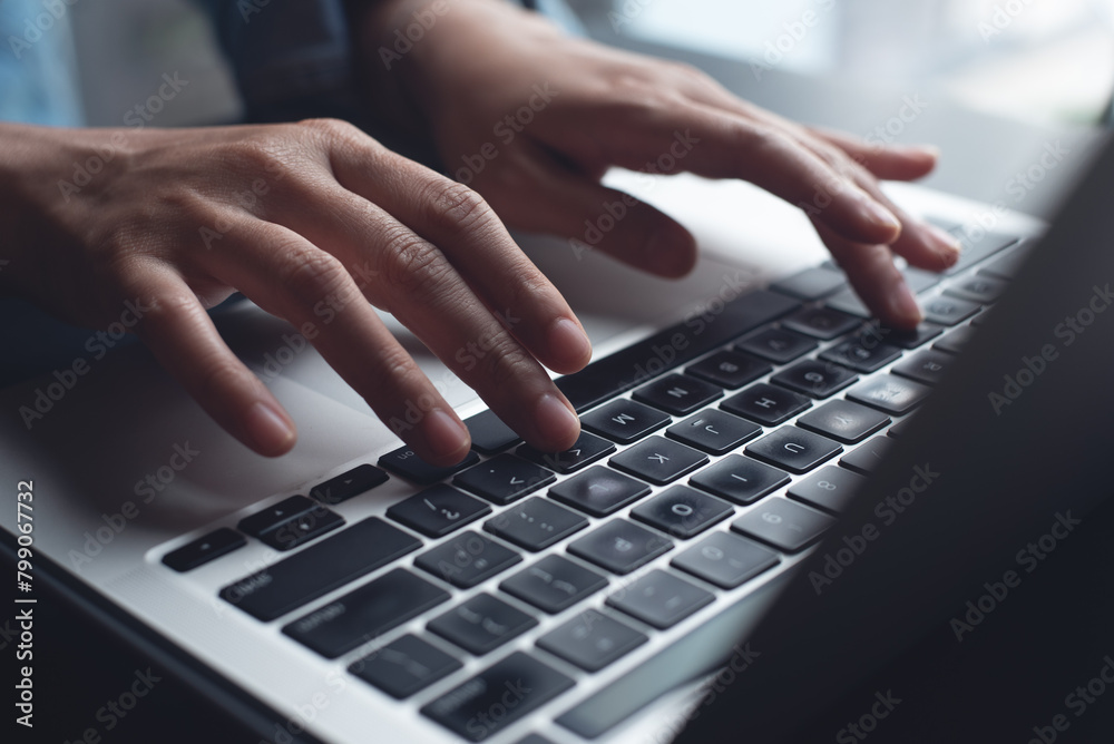 Close up of business woman hands working, typing on laptop computer keyboard, surfing the internet on office desk, online working, telecommuting, freelancer at work concept Close up of business woman hands working, typing on laptop computer keyboard, surfing the internet on office desk, online working, telecommuting, freelancer at work concept
