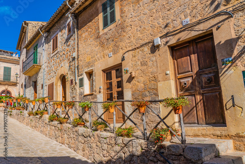 Street with flowers of Valldemossa the old mediterranean village in the mountain, landmark of Majorca island, Spain photo