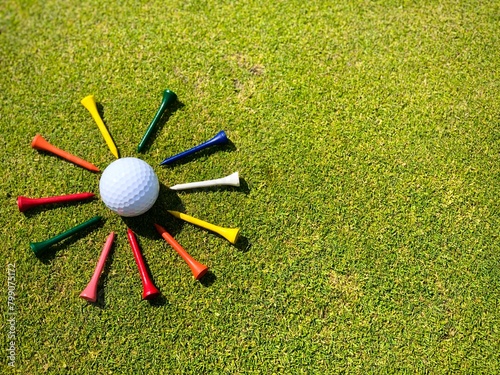 golf ball and multicolored tees
