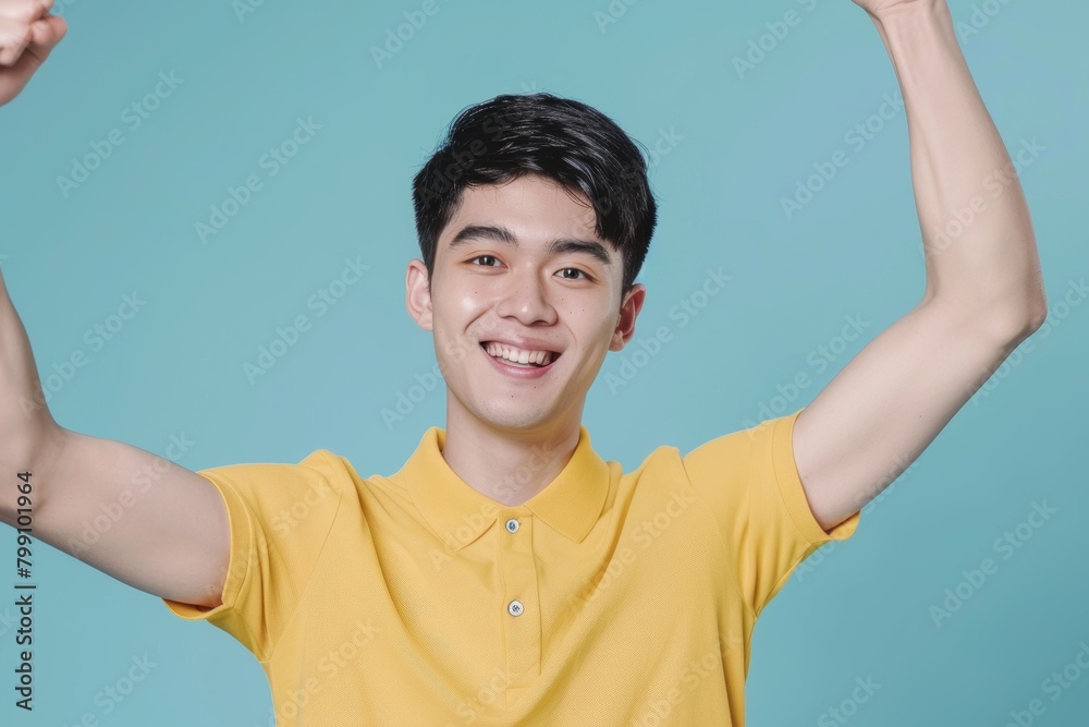 Indian man celebrates and fists in studio portrait for winning mindset, happiness, or achievement. Young model, male student, or celebration with pleased, thrilled smile or success reward