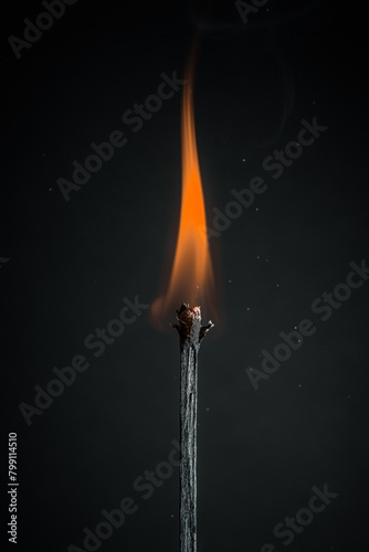 burning match on black background