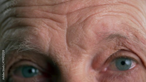 Close-up of a man raising his eyebrows and furrowing his forehead photo