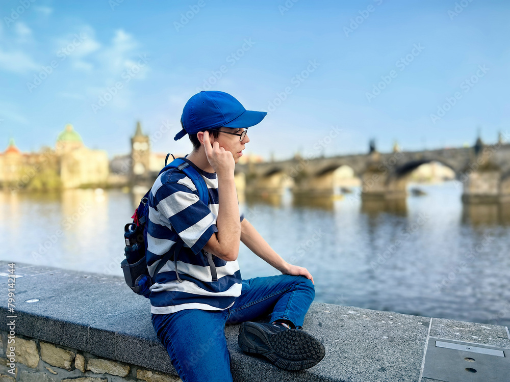 Teenager in front of Charles Bridge, Prague, Bohemia, Czech Republic