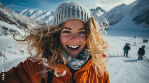 Portrait of a woman with blonde hair and blue eyes smiling in the snow