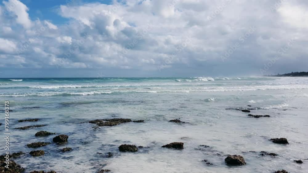 Rocky Cuban beach in Varadero, Cuba, on a cloudy day, when the sun breaks through the clouds, you can see the waves and ocean expanses. Turquoise waves. Stone slabs on the beach in the ocean. 4K Rocky Cuban beach in Varadero, Cuba, on a cloudy day, when the sun breaks through the clouds, you can see the waves and ocean expanses. Turquoise waves. Stone slabs on the beach in the ocean. 4K