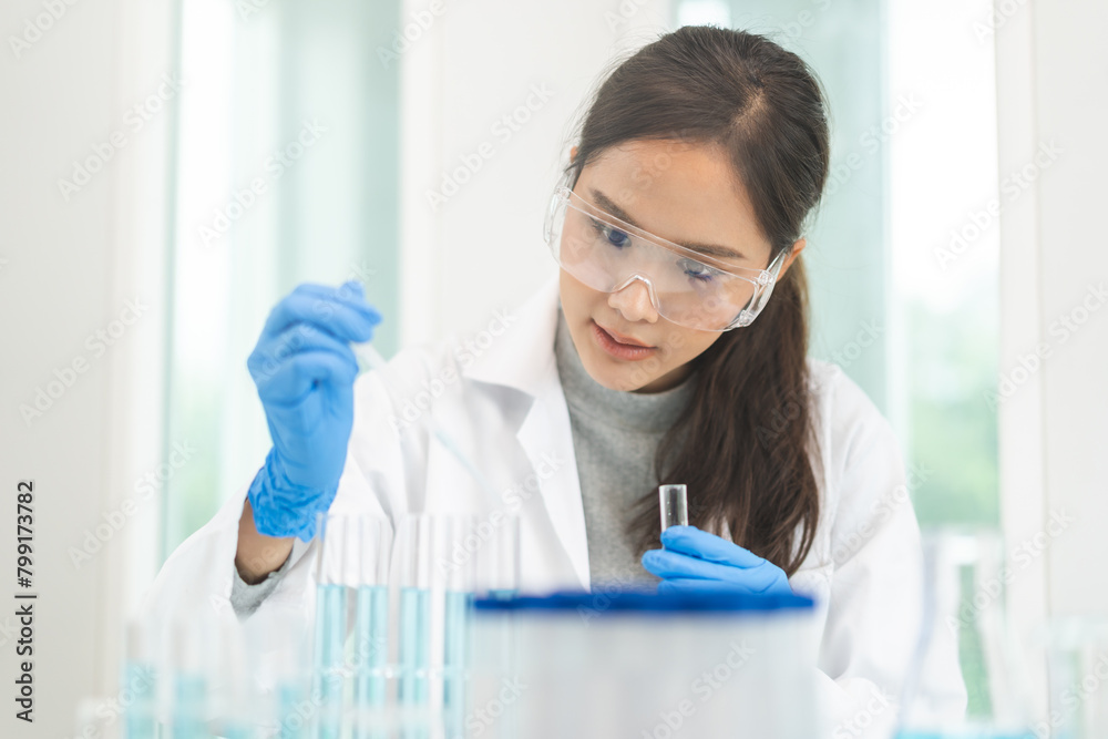 Medical development research laboratory, chemist or science scientist student hand in glove, drop water into pipette for test analysis liquid sample in clinic lab. Microbiology, analysing for medicine Medical development research laboratory, chemist or science scientist student hand in glove, drop water into pipette for test analysis liquid sample in clinic lab. Microbiology, analysing for medicine