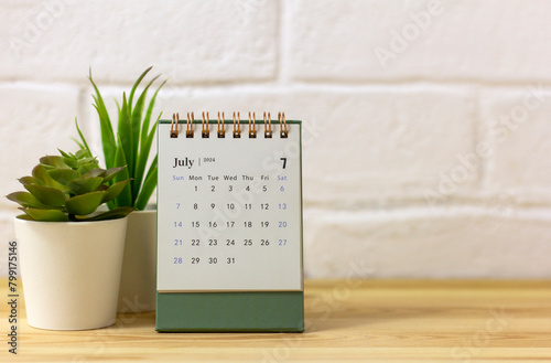 Desk calendar for July 2024 on the table with copy space.