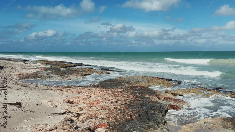 Rocky Cuban beach in Varadero, Cuba, on a cloudy day, when the sun ...