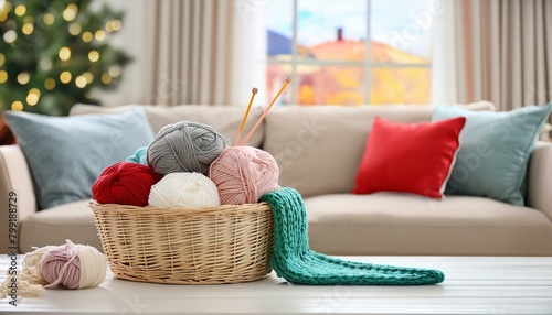 A cozy corner featuring a basket of colorful yarns and knitting needles photo