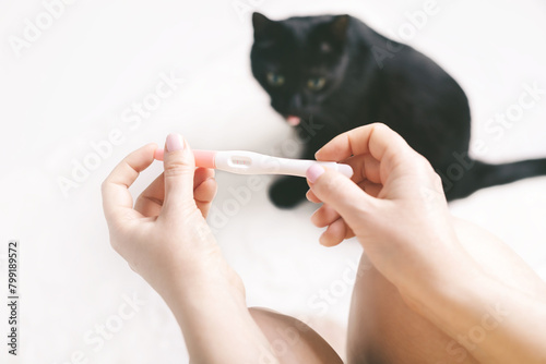 Pregnancy test with a cat in the background