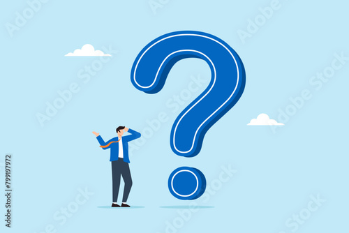 Businessman thinking while looking at big question mark, illustrating problem or challenge that requires solution. Concept of doubt or uncertainty, thinking and decision making in difficult situation