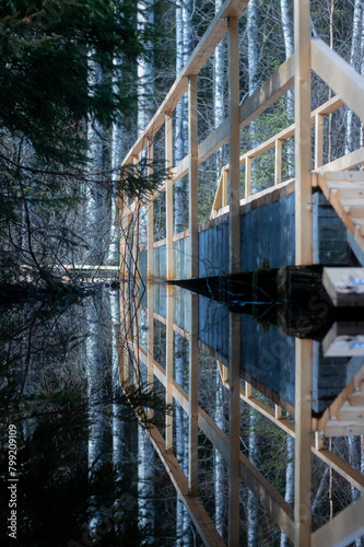 A reflection of a bridge on a flooded nature pathway. © Radio the Mountain