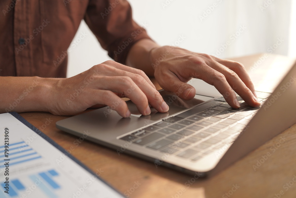 Portrait of Asian male manager working using laptop computer in modern office Male employee sitting at office and using PC See the keyboard typing screen. Enjoy working remotely Portrait of Asian male manager working using laptop computer in modern office Male employee sitting at office and using PC See the keyboard typing screen. Enjoy working remotely