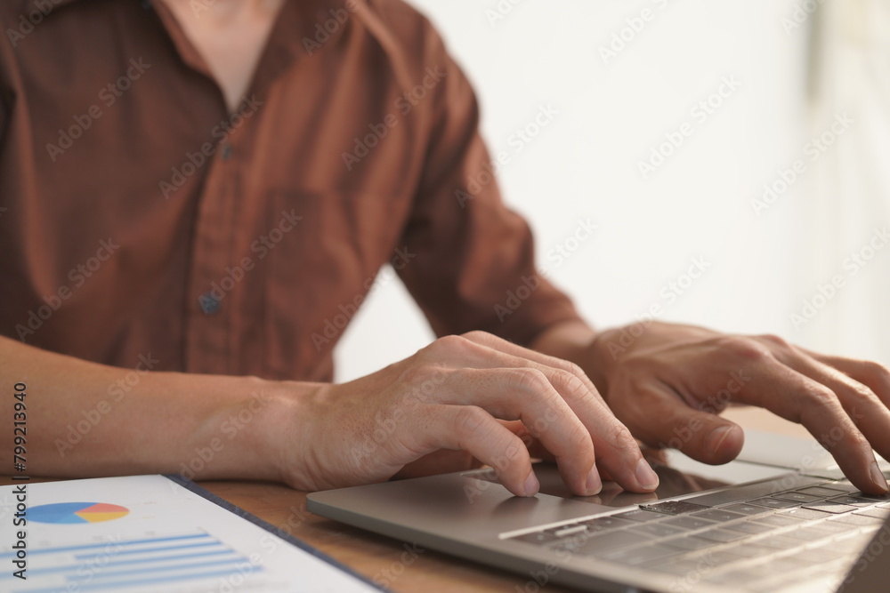 Portrait of Asian male manager working using laptop computer in modern office Male employee sitting at office and using PC See the keyboard typing screen. Enjoy working remotely Portrait of Asian male manager working using laptop computer in modern office Male employee sitting at office and using PC See the keyboard typing screen. Enjoy working remotely