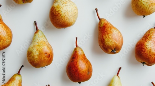 Group of ripe pears on white surface