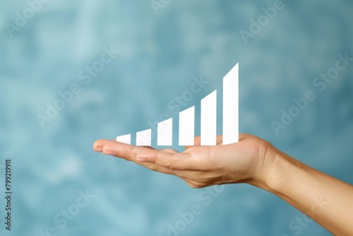 Close-up of a Hand Holding a Rising Bar Chart - Growth, Success, Financial Analysis photo