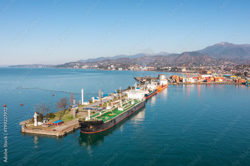 Aerial view industrial cargo and oil port with ship tanker vessel loading in gas and oil terminal station refinery, Batumi, Georgia, Global trading import export logistic transport sea freight