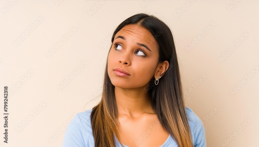 Young woman having doubts while looking up Young woman having doubts while looking up