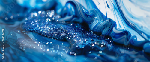 Electric blue marble ink sweeps across a captivating abstract setting, embellished with glistening glitters. photo