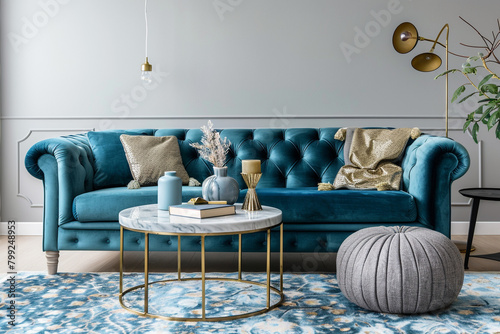 A refined living room with a cerulean velvet sofa, minimalist coffee table, and delicate gold accents, complemented by a plush carpet and elegant pouf, all in vivid ultra HD. photo