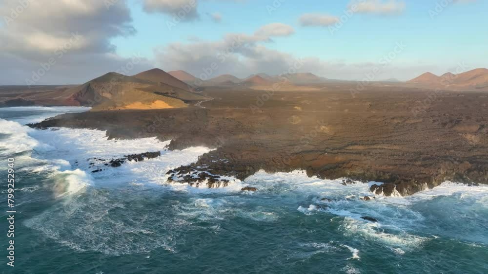 aerial slow motion view of ocean and giant waves crashing at rocky cliff with splashing and white foam. Lanzarote. Canary islands, Spain aerial slow motion view of ocean and giant waves crashing at rocky cliff with splashing and white foam. Lanzarote. Canary islands, Spain