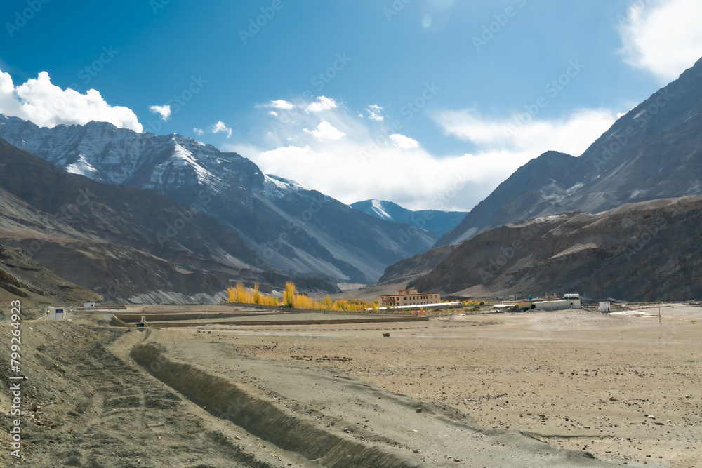 Beautiful landscape with yellow-orange leaves in the October dry season and emerald green streams. blue sky There are mountains in the background at Ladakh in the Indian Himalayas. Beautiful landscape with yellow-orange leaves in the October dry season and emerald green streams. blue sky There are mountains in the background at Ladakh in the Indian Himalayas.