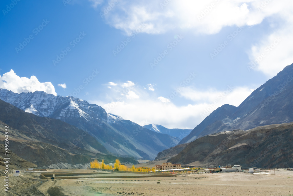 Beautiful landscape with yellow-orange leaves in the October dry season and emerald green streams. blue sky There are mountains in the background at Ladakh in the Indian Himalayas. Beautiful landscape with yellow-orange leaves in the October dry season and emerald green streams. blue sky There are mountains in the background at Ladakh in the Indian Himalayas.