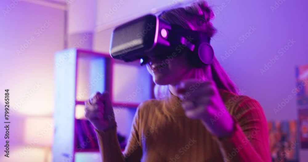 Gaming, virtual reality and woman boxing in home at night for entertainment, online games and esports. Gamer, neon lighting and person with vr goggles for metaverse, cyber world and competition Gaming, virtual reality and woman boxing in home at night for entertainment, online games and esports. Gamer, neon lighting and person with vr goggles for metaverse, cyber world and competition